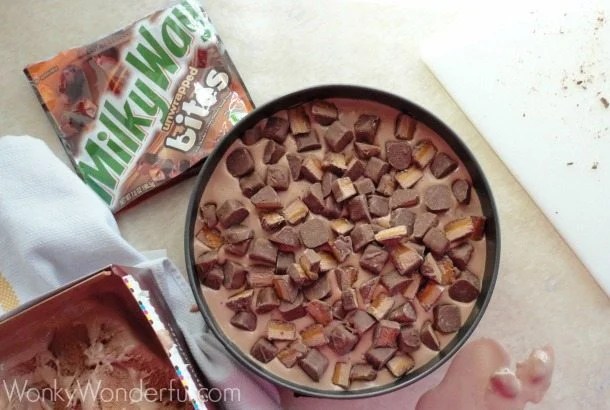 chopped candy bar pieces in round pan next to Milky Way package