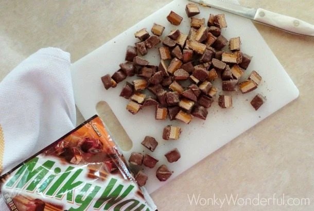 Milky Way package next to cutting board with chopped Milky Way candy bars