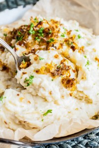 mashed potatoes being scooped with serving spoon