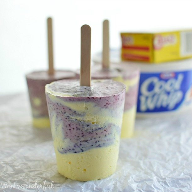 three frozen popsicles with cool whip and jello in background