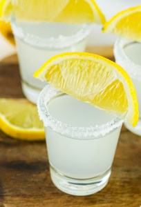 clear shots topped with lemon wedges