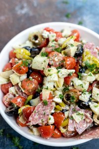 meat cheese and veggie salad in white bowl