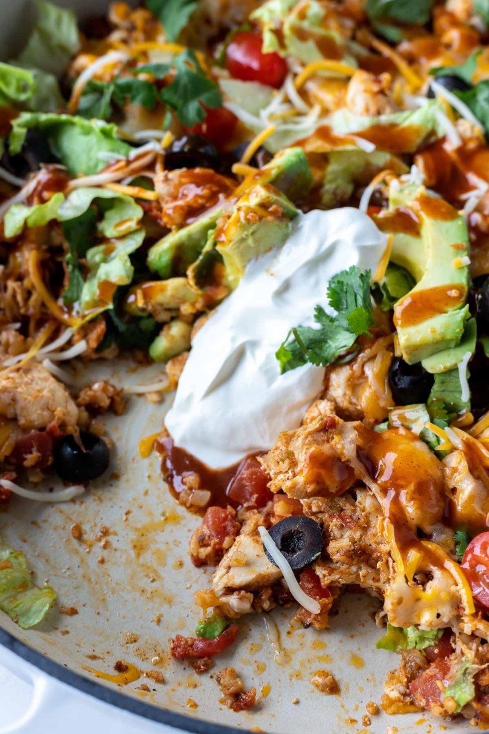 casserole topped with sour cream in casserole dish