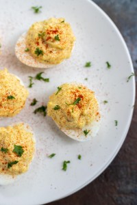 deviled eggs sprinkled with paprika and parsley