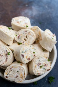 prepared pinwheels stacked in white bowl