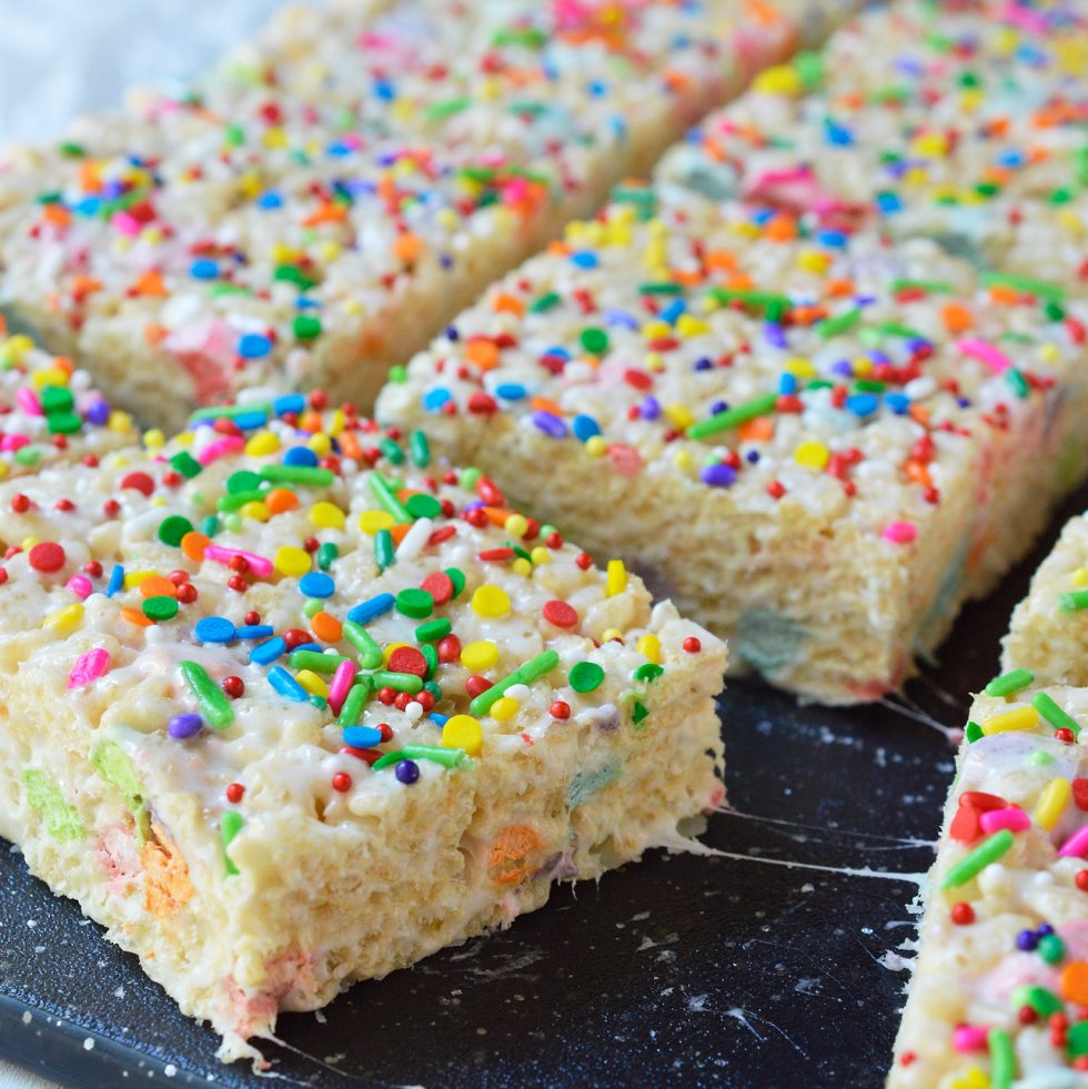 These Magical Rainbow Rice Crispy Treats are perfect for a surprise treat or a colorful unicorn party! This easy dessert recipe makes super chewy krispy treats full of magical charm marshmallows. Top them with rainbow sprinkles for the ultimate kid approved treat!