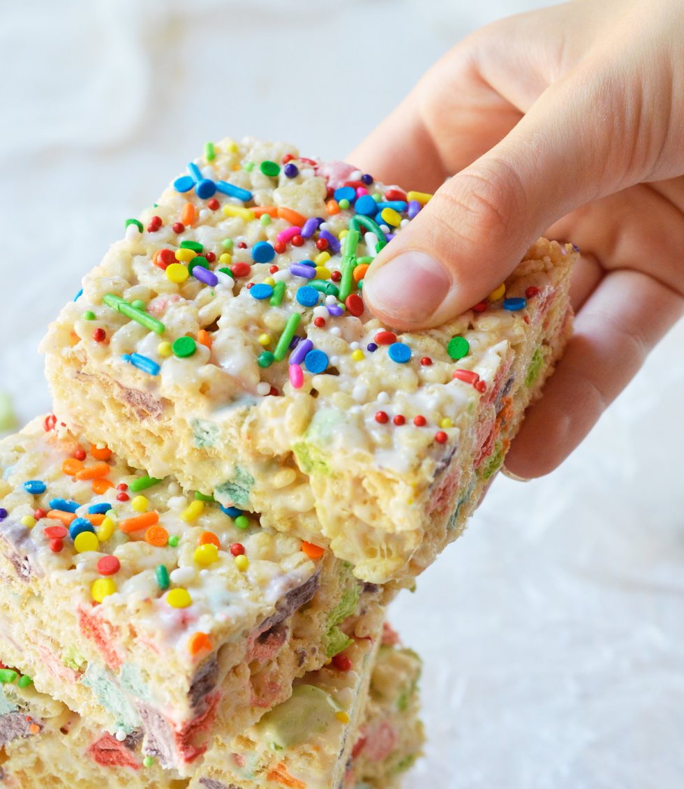 These Magical Rainbow Rice Crispy Treats are perfect for a surprise treat or a colorful unicorn party! This easy dessert recipe makes super chewy krispy treats full of magical charm marshmallows. Top them with rainbow sprinkles for the ultimate kid approved treat!