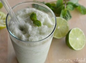 clear glass filled with creamy smoothie topped with mint leaf