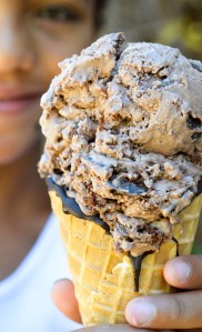 kid holding cone filled with chocolate ice cream