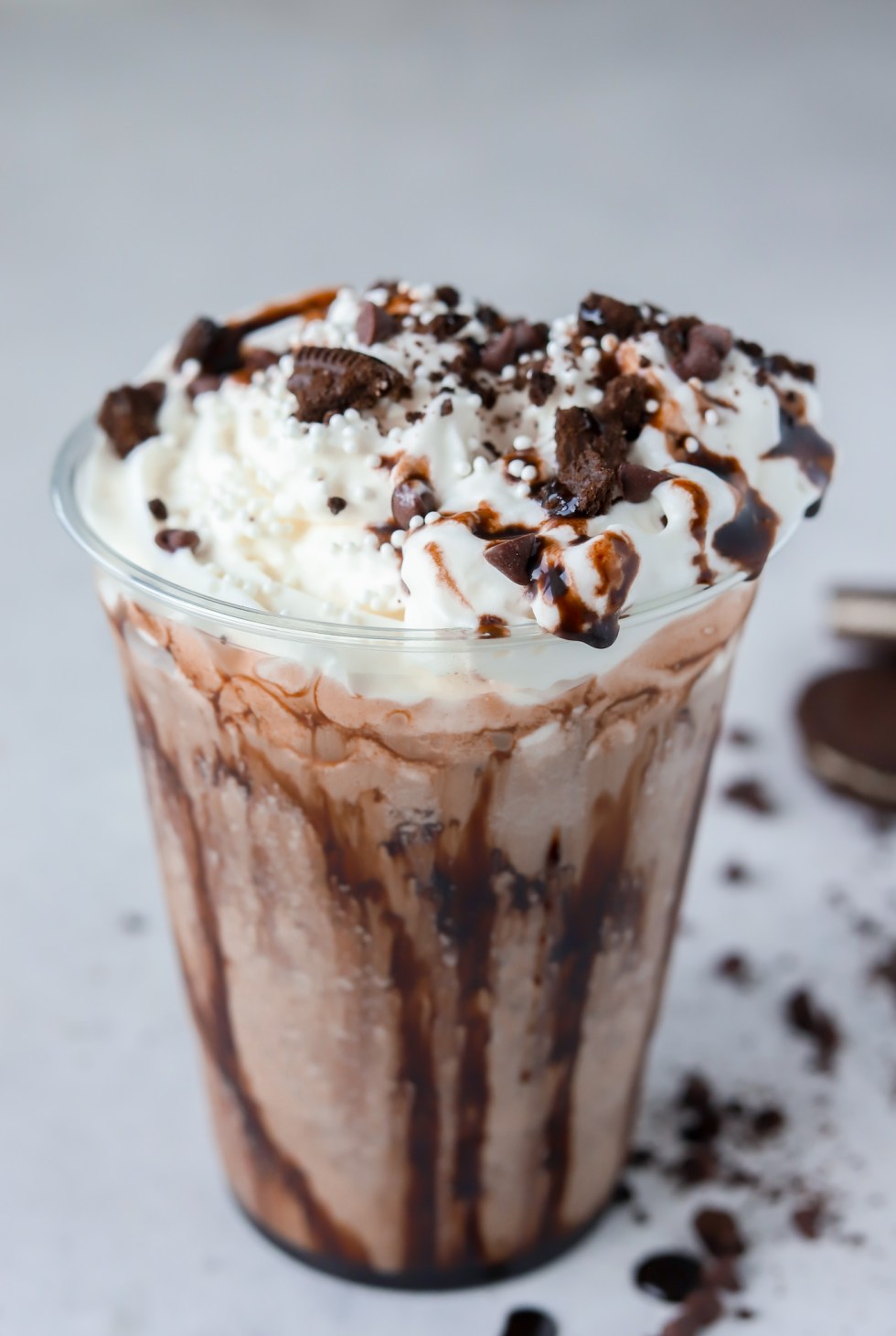 blended coffee topped with whipped cream and cookie crumbles