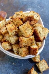 golden brown croutons in white bowl