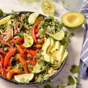 peppers, avocado, pork and limes in blue serving bowl