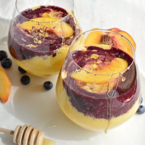 If you enjoy healthy smoothie recipes and unexpected flavor combinations these Peach Smoothies with Wild Blueberry Swirl are for you! Fresh peaches and frozen wild blueberries make a delicious and beautiful meal. vegetarian