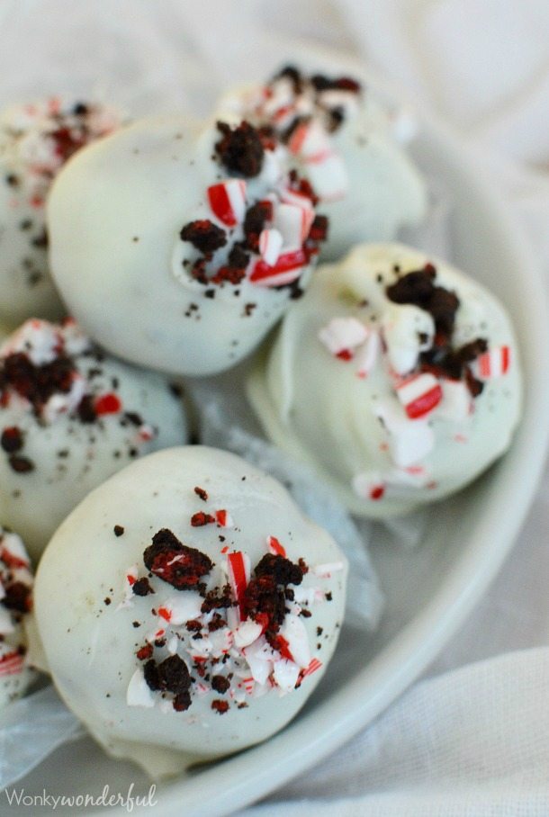 white coated balls topped with crushed Oreos and candy canes