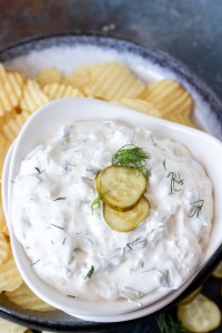 creamy dip topped with pickle slices and fresh dill