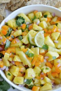 If you want a fresh and fruity summer snack, make this Pineapple Salsa Recipe! It just takes a few simple ingredients and about 5 minutes to make this tasty appetizer. Perfect for summertime parties and backyard barbecues!