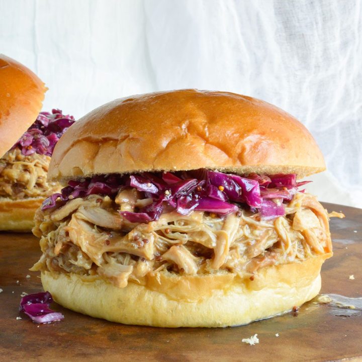 Slow Cooker Honey Mustard Shredded Chicken Sandwich Recipe - This easy dinner is made in your crockpot with just 4 ingredients! A pulled chicken sandwich with sweet and tangy honey mustard flavor!