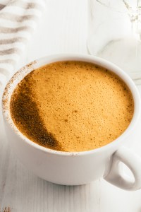 foamy tan drink in white mug