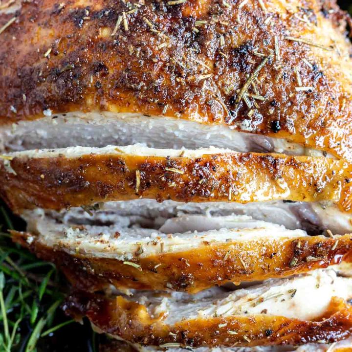 cooked turkey breast sliced showing the white meat inside