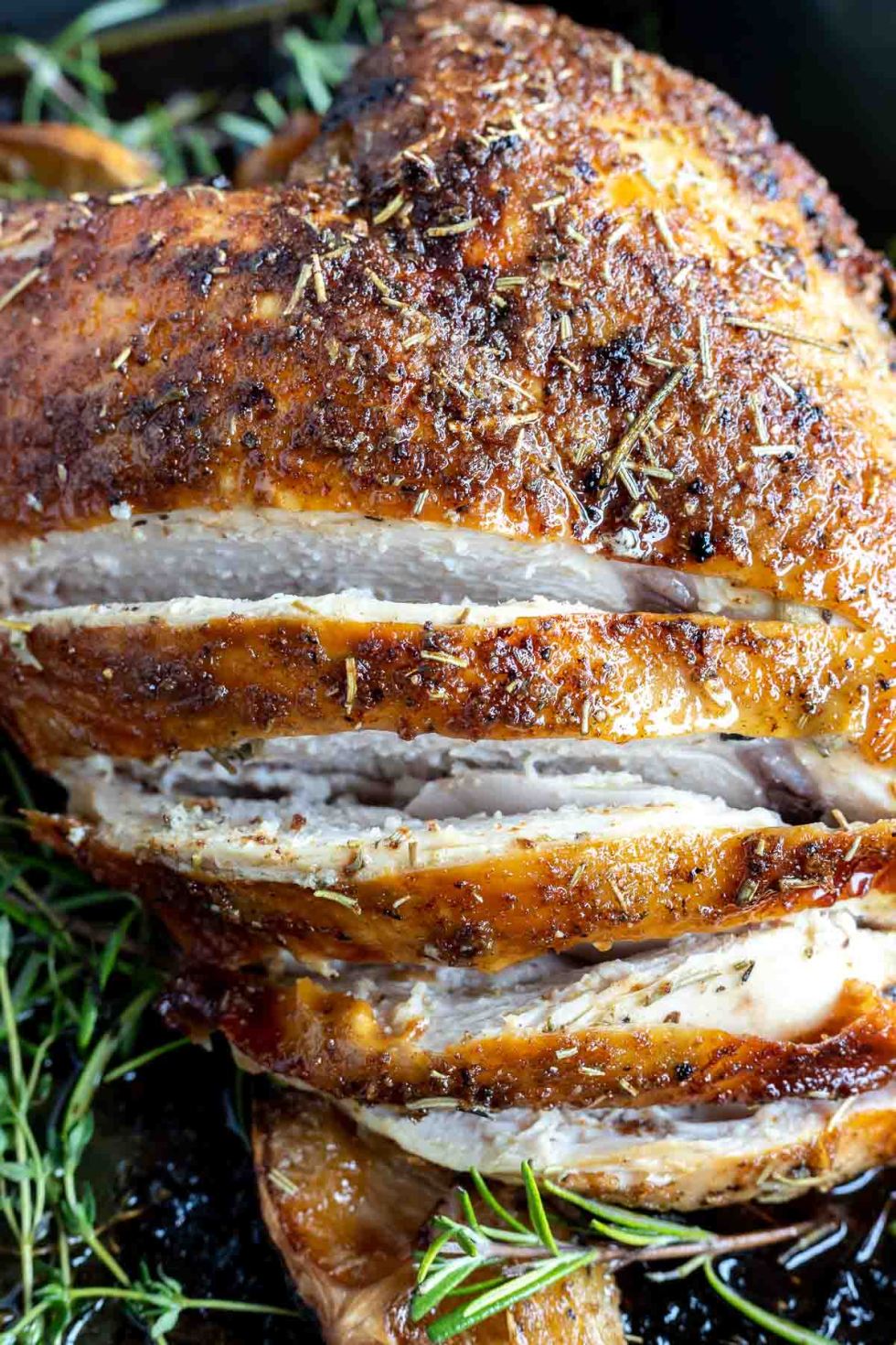 cooked turkey breast sliced showing the white meat inside 