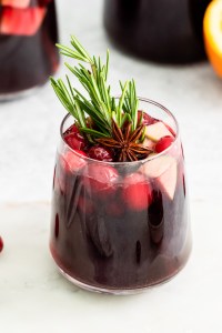 wine fruit and rosemary in clear glass