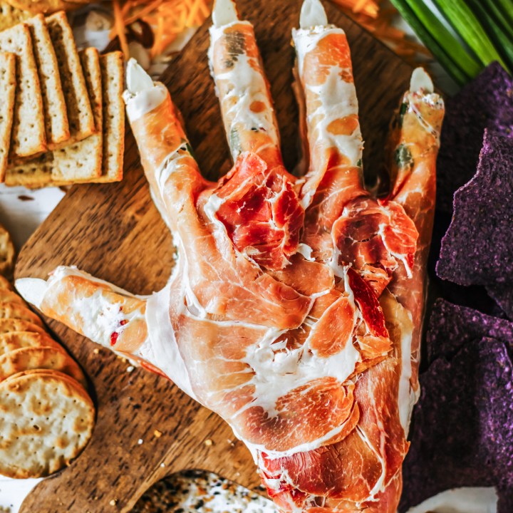 hand shaped cheese ball surrounded by crackers