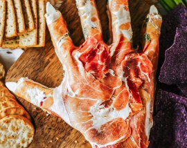 hand shaped cheese ball surrounded by crackers