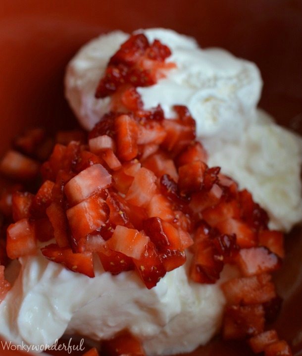 chopped red strawberries and white mixture in bowl