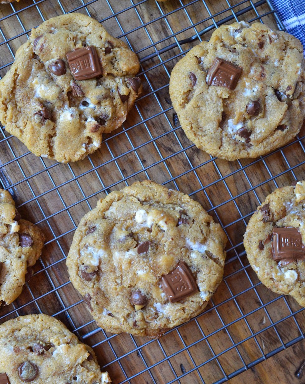 This fun twist on your favorite cookie is filled with S'mores goodness. S'mores Chewy Chocolate Chip Cookies make a great summertime dessert that can be enjoyed inside or outside! Marshmallows, chocolate and graham crackers make this super chewy cookie recipe extra special.