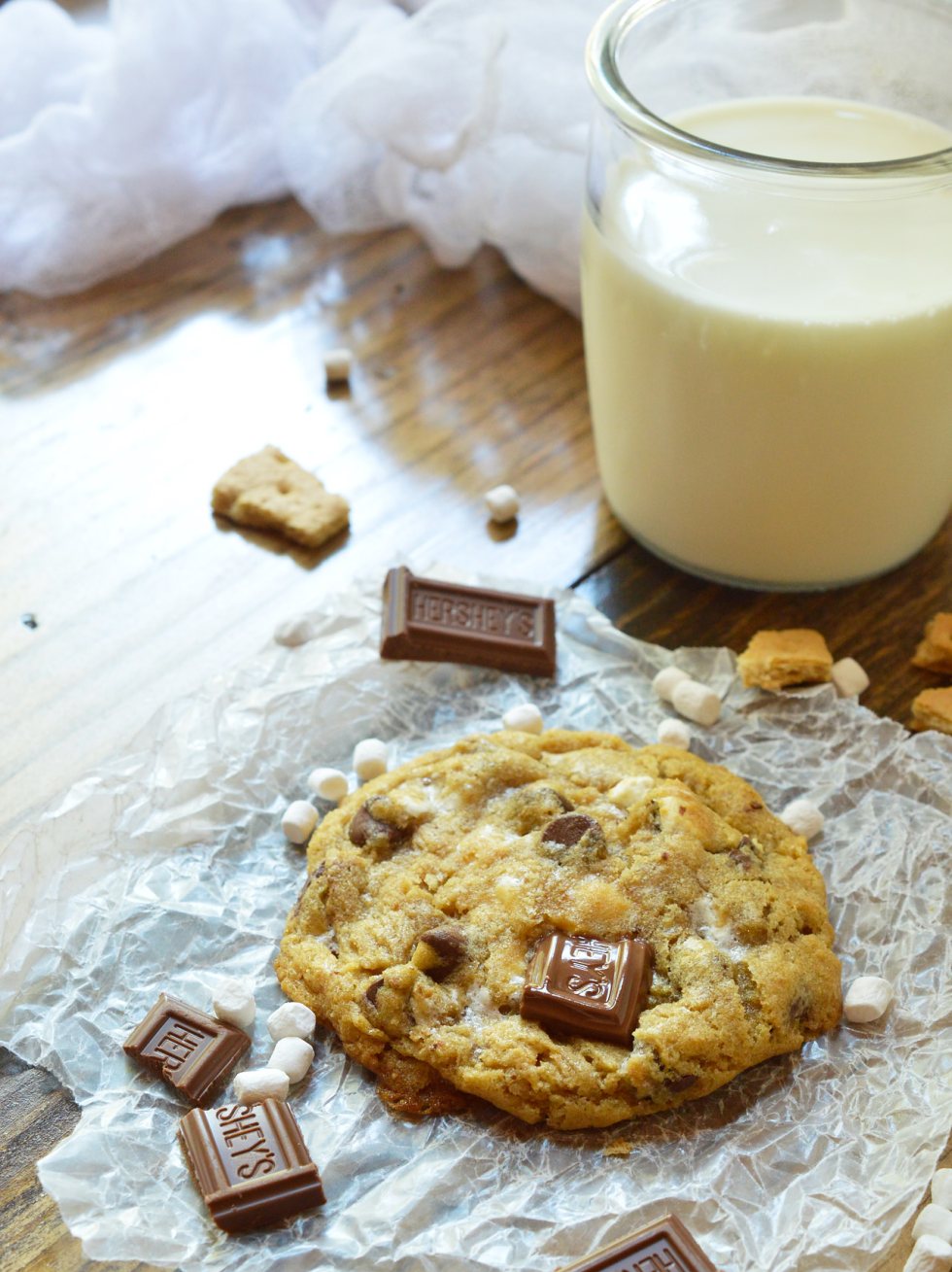 This fun twist on your favorite cookie is filled with S'mores goodness. S'mores Chewy Chocolate Chip Cookies make a great summertime dessert that can be enjoyed inside or outside! Marshmallows, chocolate and graham crackers make this super chewy cookie recipe extra special.