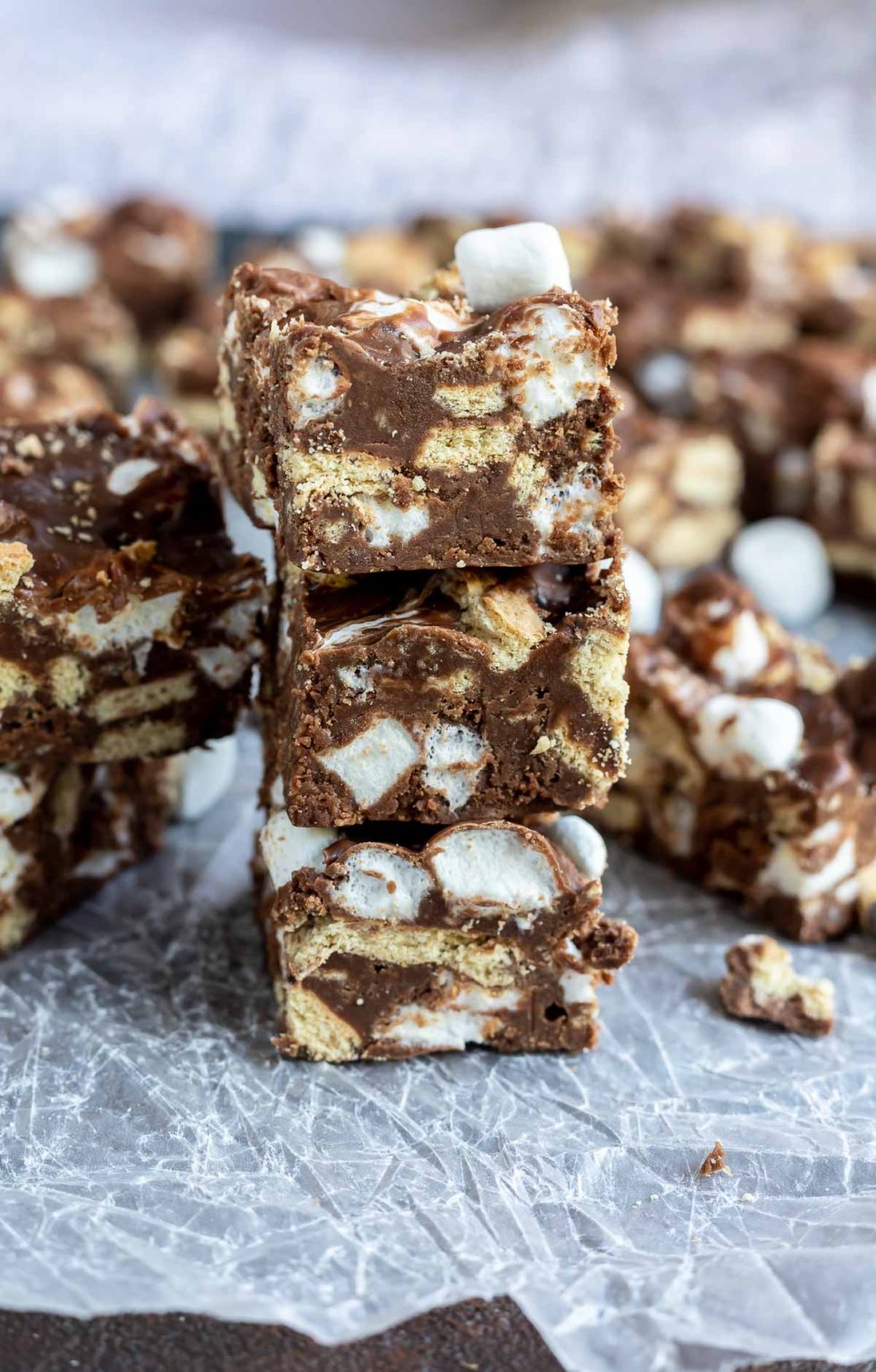 fudge squares stacked on wax paper