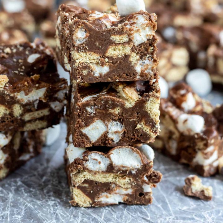 fudge squares stacked on wax paper