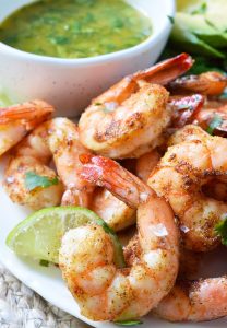 For punch in the face flavor, make these Cilantro Lime Spicy Baked Shrimp! This Whole30 compliant recipe starts with shrimp covered in spices, baked to perfection then served with a fresh cilantro lime dip. Perfect for a healthy lunch, dinner, appetizer or a snack!