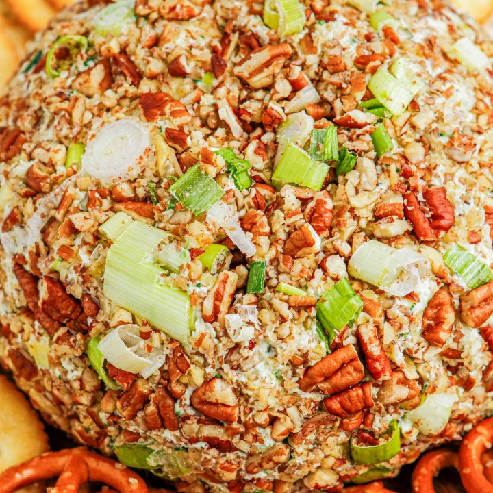 prepared cheese ball coated in nuts and green onions