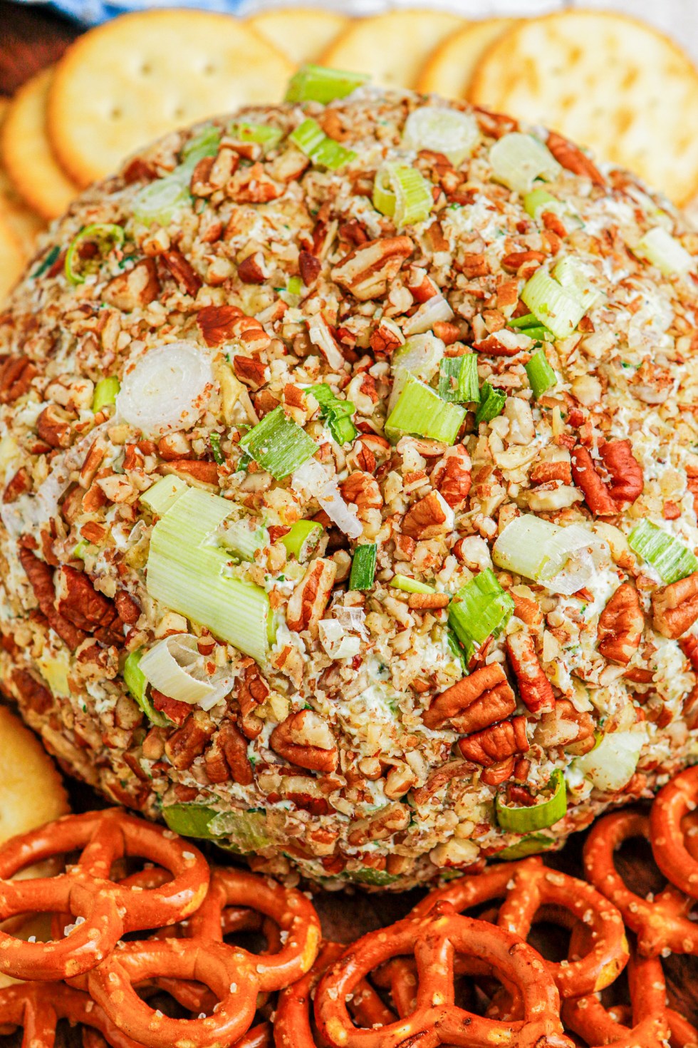 prepared cheese ball coated in nuts and green onions