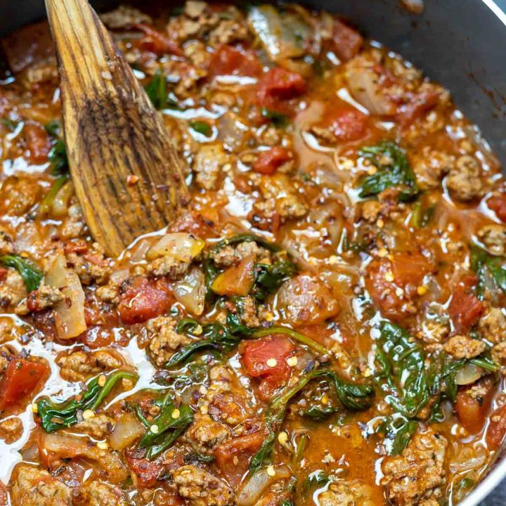 prepared tomato pasta sauce in pot with wooden spoon