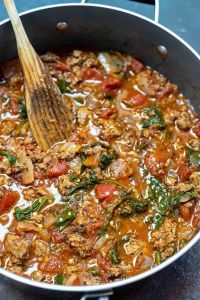 prepared tomato pasta sauce in pot with wooden spoon