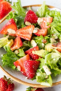 lettuce fresh strawberries and avocado in bowl