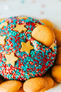 prepared cheese ball with cookie stuck in it