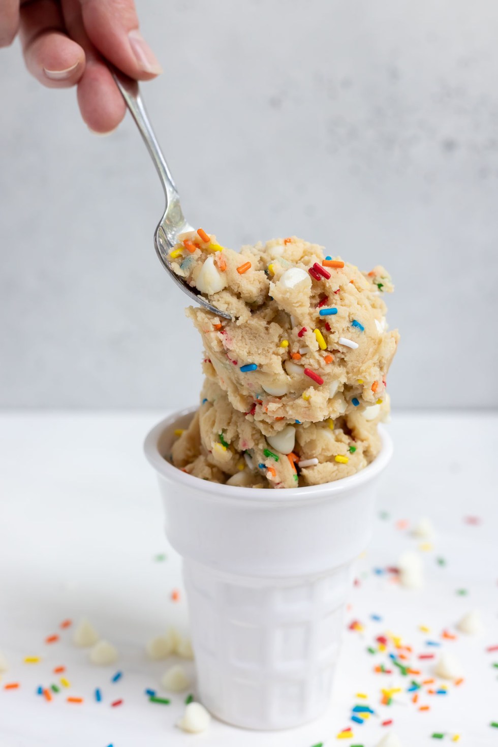 hand scooping edible cookie dough with mini spoon