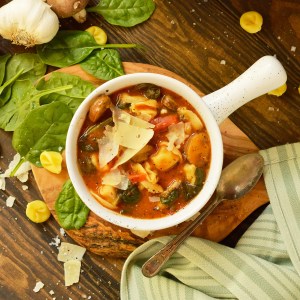 white bowl filled with soup and a spoon on the side