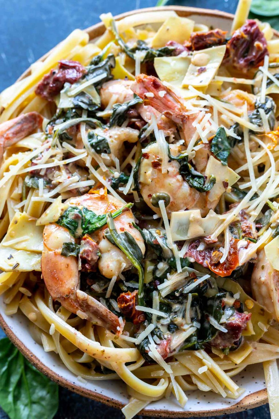 shrimp and sauce tossed with pasta and served in white bowl