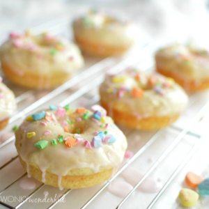 glazed donuts topped with crushed candy on wire rack