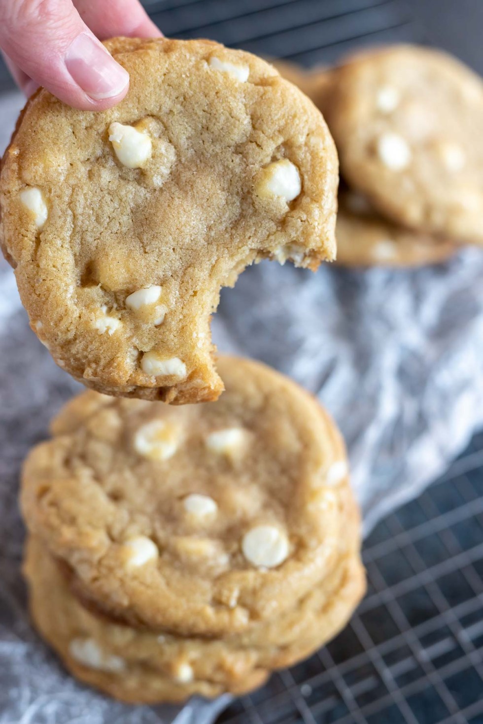 hand holding cookie with bite taken out