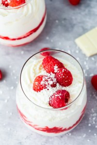 white mousse topped with fresh raspberries